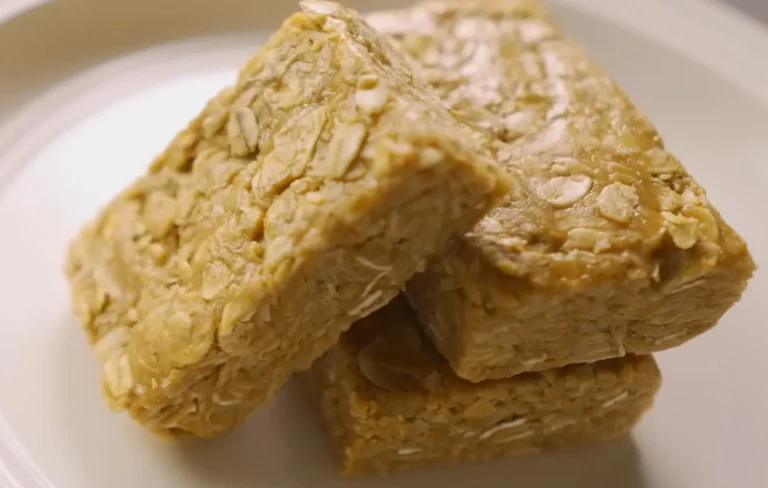 Three stacked flapjack squares on a plate, showing a chewy oat texture with visible rolled oats, perfect for a healthy flapjack recipe.