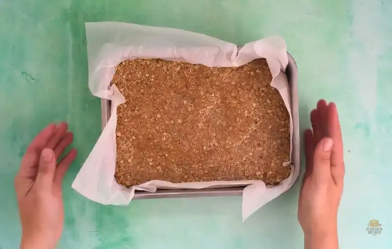 Flapjack mixture pressed into a lined baking tin